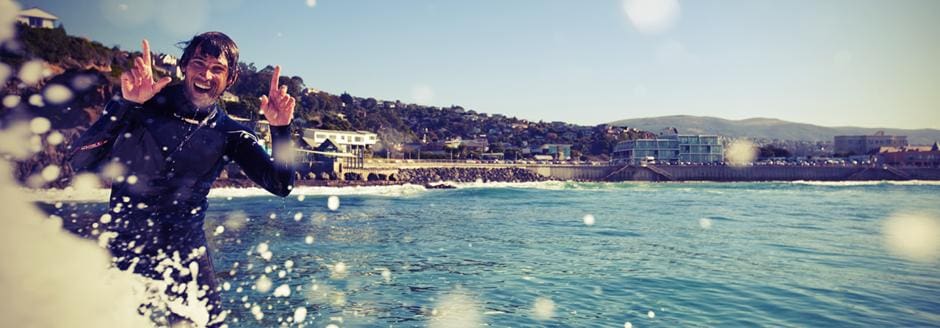 surfer at clairs beach dunedin